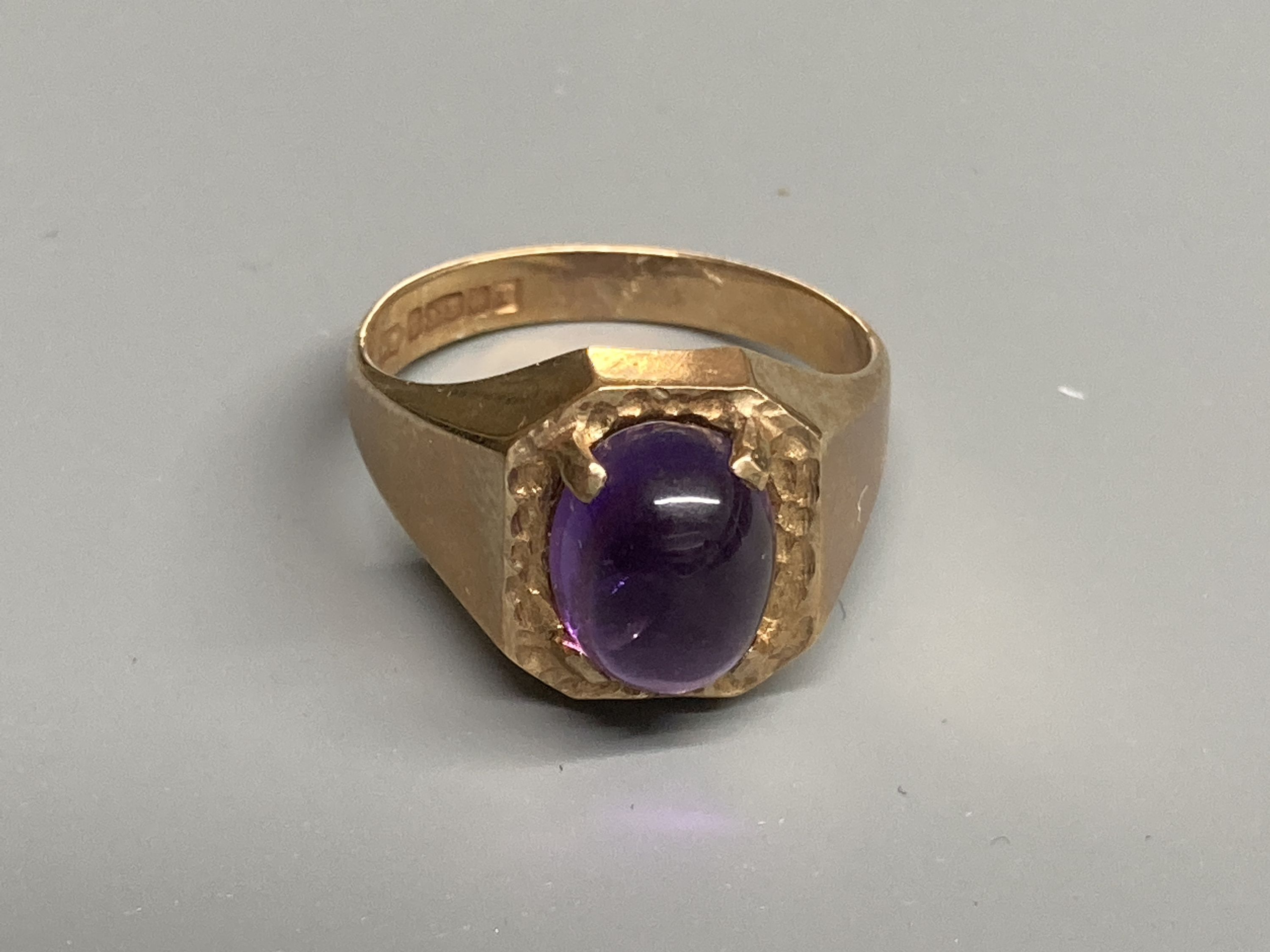 Two modern 9ct gold and cabochon amethyst set dress rings, sizes Q/R & T
